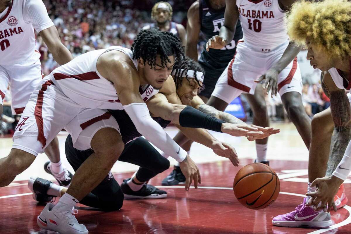 Alabama guard Jaden Shackelford, left, and Texas A&M forward Ethan Henderson battle for the ball during the first half. Shackleford finished with 16 points as Henderson and the Aggies pulled off the upset.