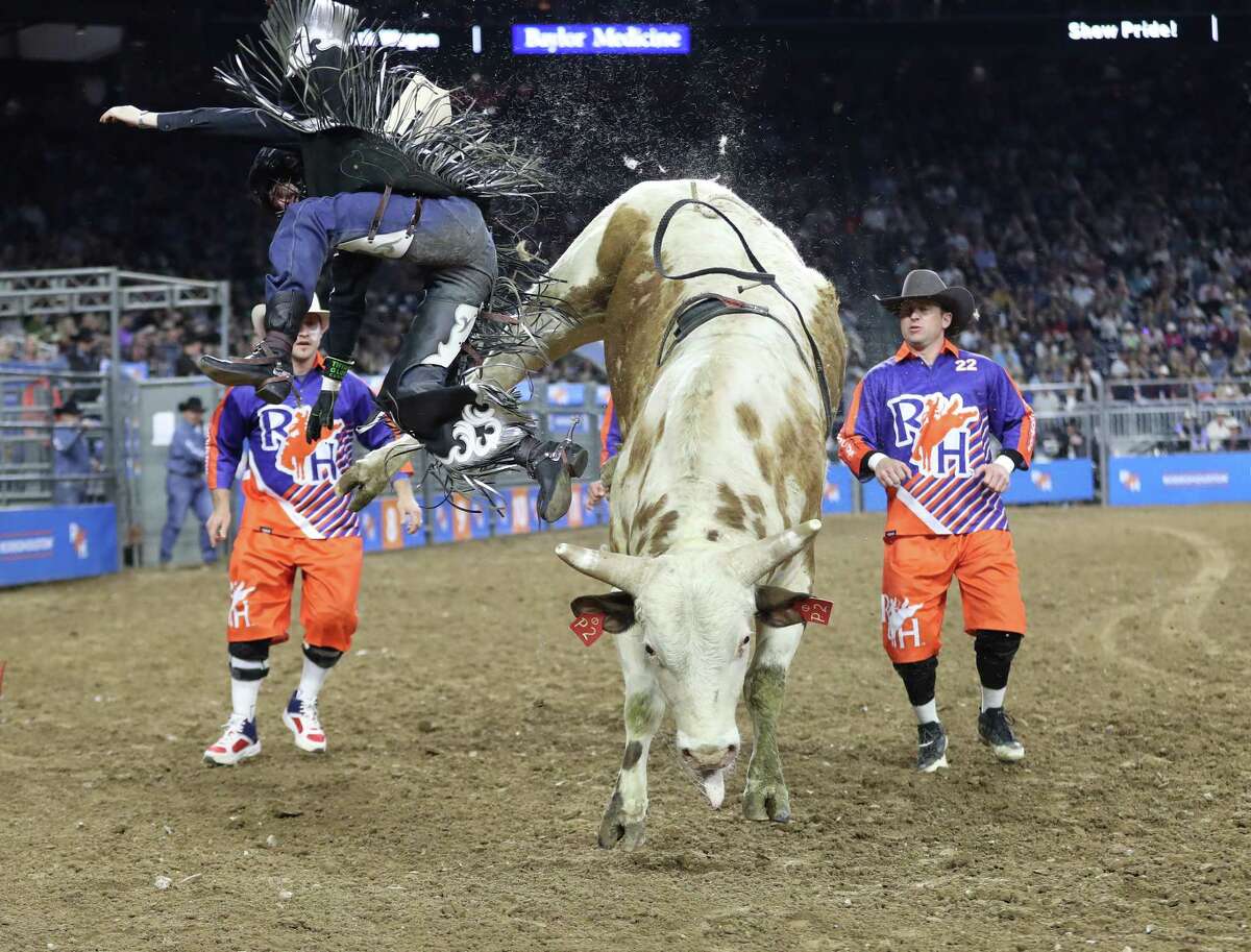 Ky Hamilton hops off of Muscle Milk after his ride in the Bull Riding competition during round three of Super Series 1 at the Houston Livestock Show and Rodeo at NRG Stadium on Wednesday, March 2, 2022 in Houston.