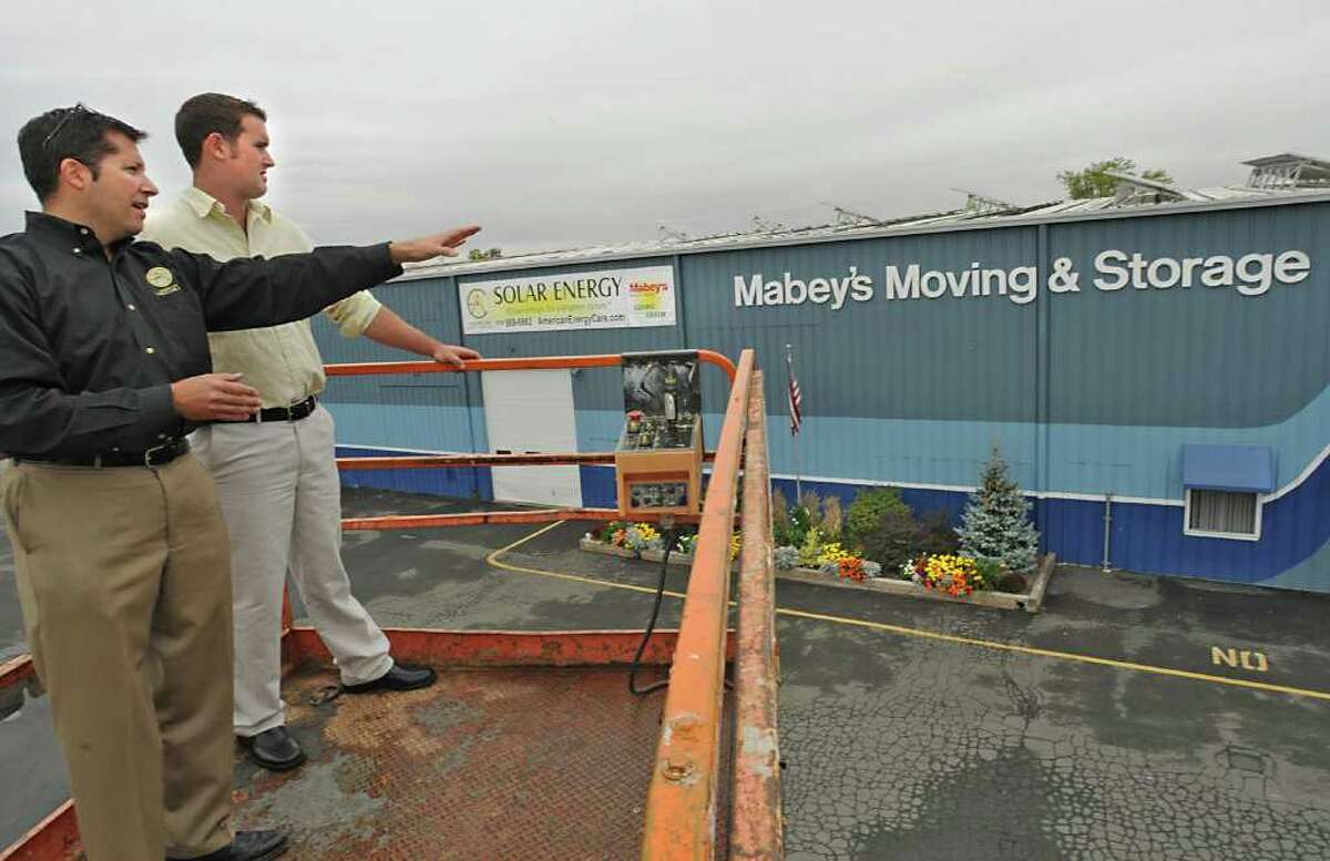 From left, Jamie Thompson, President/CEO of American Energy Care, Inc., and Greg Blass, Facilities Operator of Maybey's Moving & Storage look over the solar panels on top of Maybey's Moving & Storage facility in East Greenbush, NY on September 27, 2010. (Lori Van Buren / Times Union)