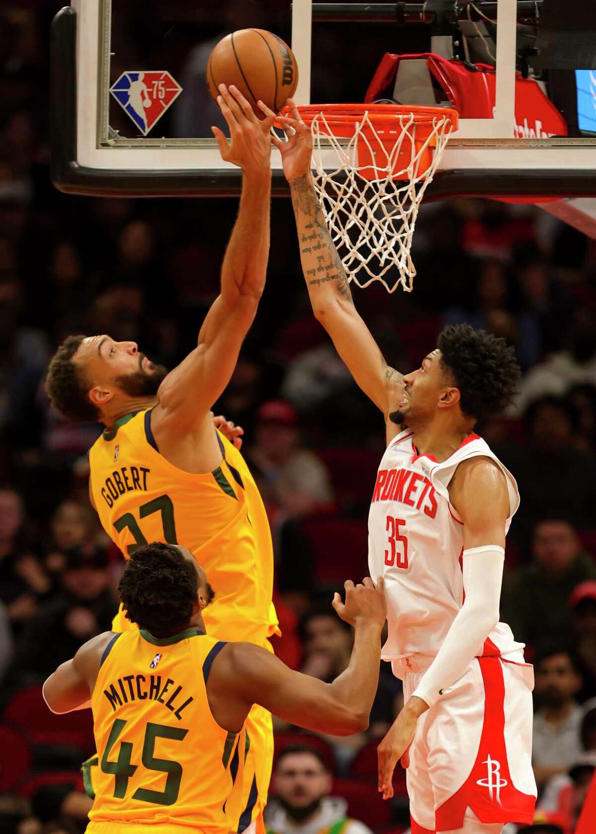 Utah Jazz center Rudy Gobert (27) tries to shoot over Houston Rockets center Christian Wood (35) during the overtime period of an NBA game between the Houston Rockets and Utah Jazz on Wednesday, March 2, 2022, at Toyota Center in Houston.