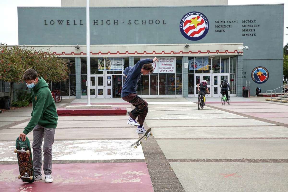 Junior Nolan Kurpius, 16, performs a trick on his skateboard in front of San Francisco’s Lowell High School in August.