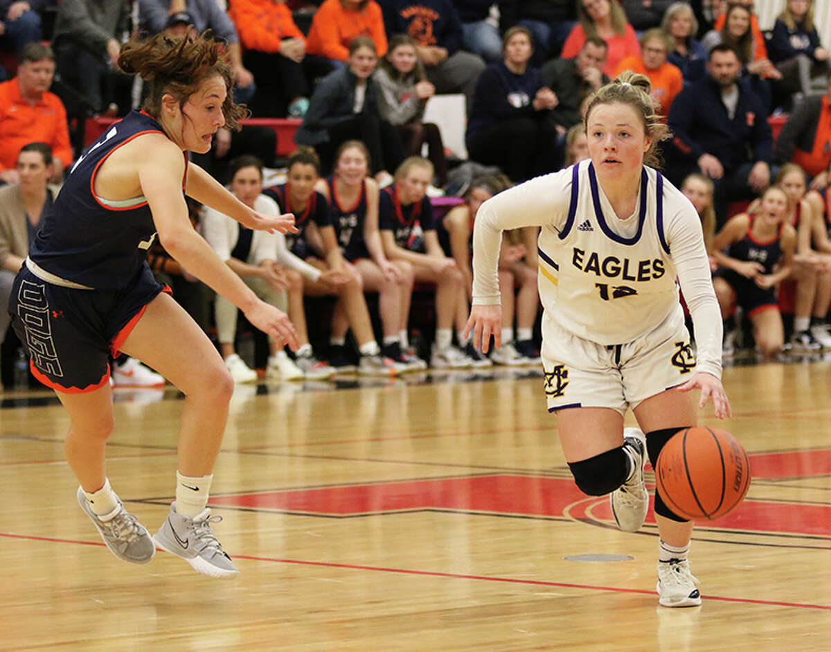 CM's Aubree Wallace (right) handles the ball against Mahomet-Seymour's Cayla Koerner in the second half Monday night at the Highland Class 3A Super-Sectional.