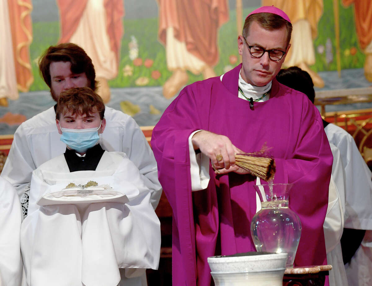 Bishop David Toups blesses the ashes before distributing them to those gathered at the mid-day Ash Wednesday Mass at St. Anthony Cathedral Basilica. The service kicks off the 40 days of abstinance and solemnity leading up to Easter. Photo made Wednesday, March 2, 2022 Kim Brent/The Enterprise