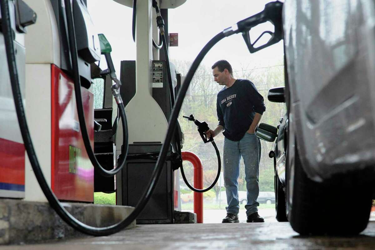 A driver pumps gas at a station in Connecticut.