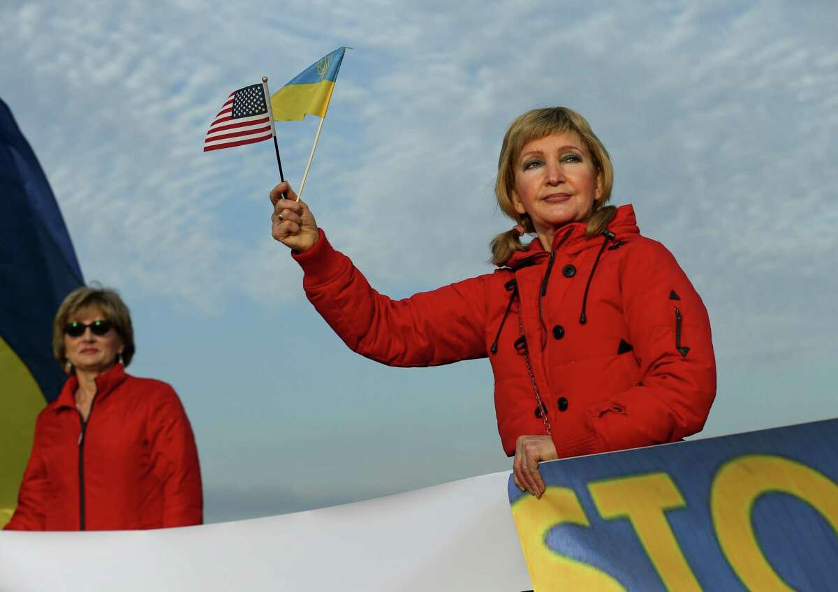 Larysa Drobot holds a Ukrainian and an American flag while protesting the ongoing Russian invasion of Ukraine, outside Schlumberger on Thursday, March 3, 2022, in Sugar Land. The group is looking to apply pressure on the oilfield services company to pull its money out of Russia.
