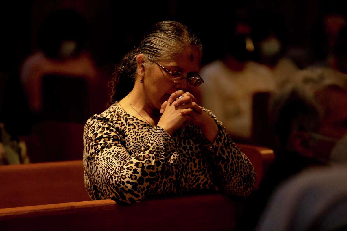 Dorothy Sanchez prays during a prayer service for Ukraine at the Oblate School of Theology Chapel.