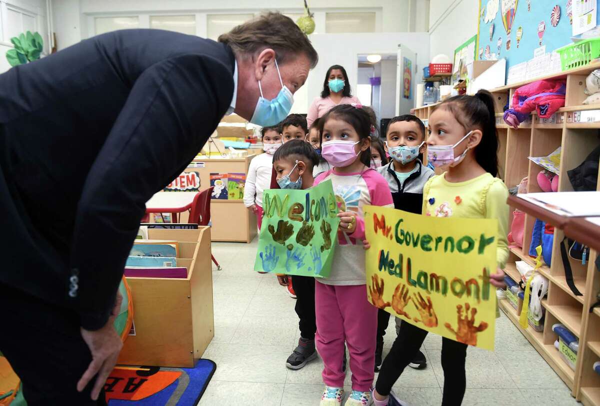 From left, Gov. Ned Lamont meets with Arianna Vinan, 4, and Kaylee Solanos, 5, and their pre-K class at the Catholic Charities St. Francis and St. Rose of Lima Child Development Center in the Fair Haven section of New Haven before a press conference Thursday concerning House Bill 5045, which addresses childhood lead poisoning.
