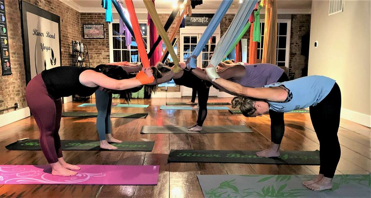Participants do aerial yoga at River Bend Yoga, owned by Vicky Delaney, in this file photo. The business is moving to 100 W. 3rd St.
