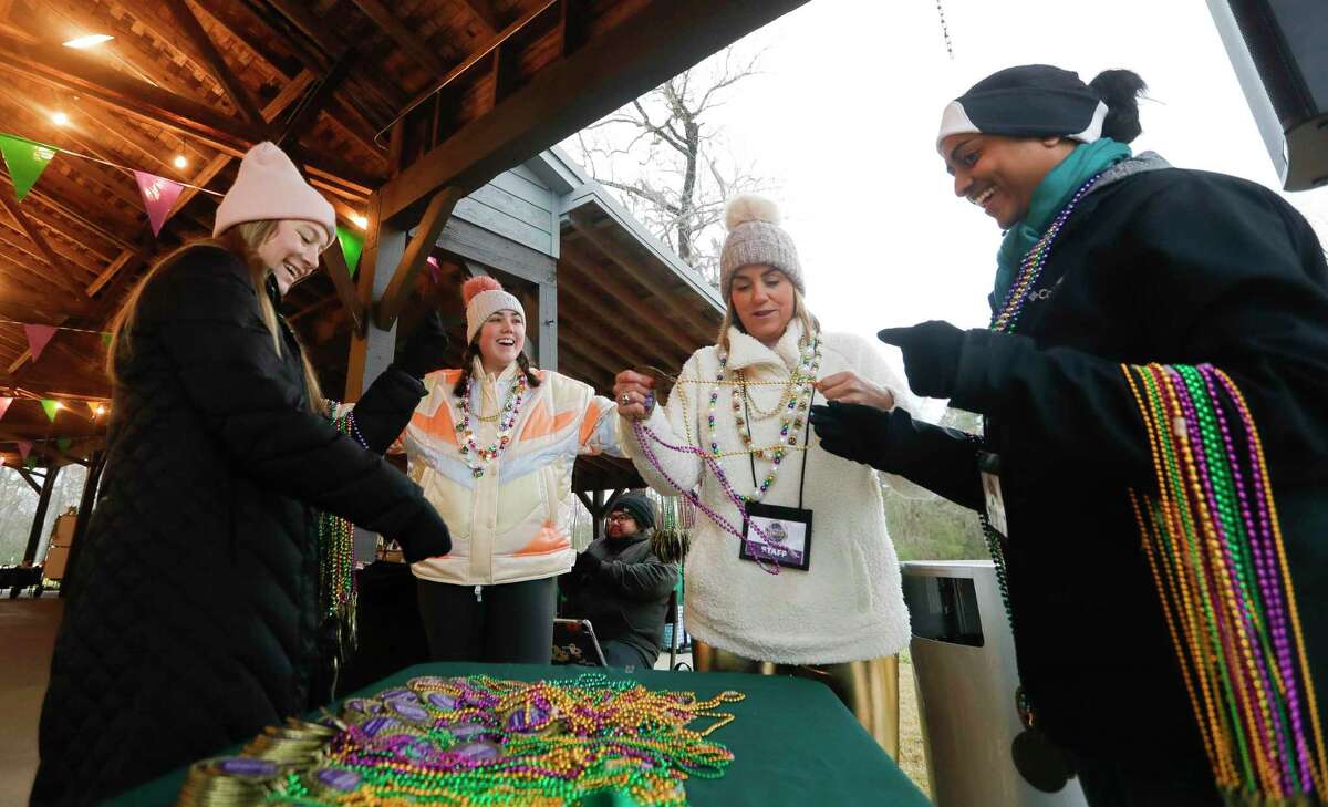 Volunteers sort Mardi Gras-themed medals during Montgomery County Food Bank’s inaugural Outrun Hunger fun run at Grand Central Park, Saturday, Feb. 26, 2022, in Conroe.