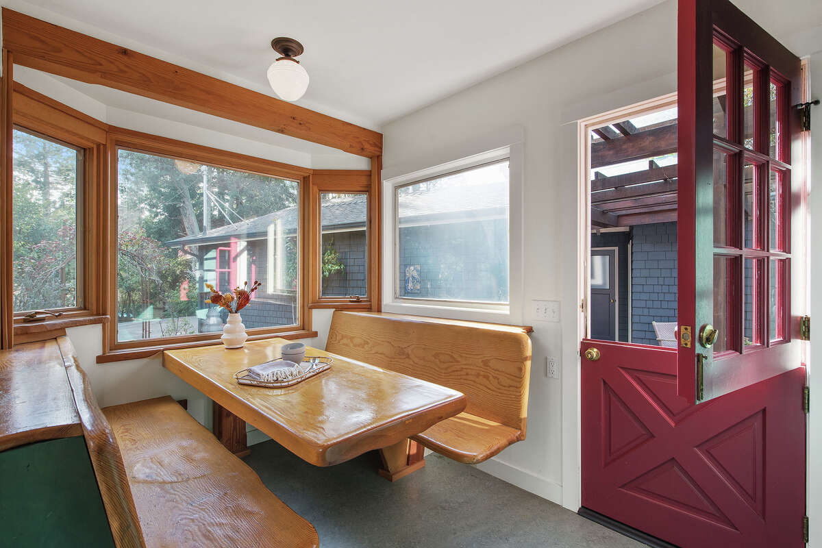 A charming breakfast nook overlooks and opens to the property.