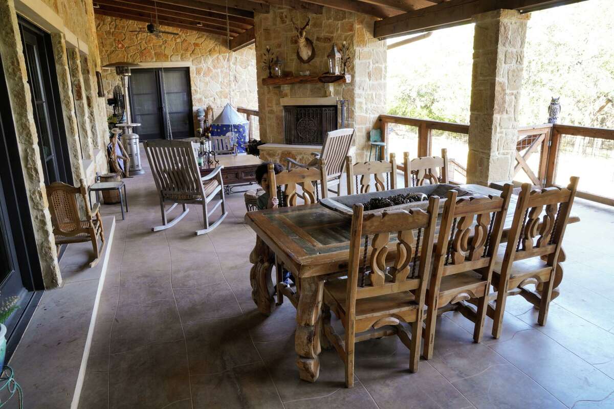 Much of the outdoor kitchen and dining area is faced with tumbled Hill Country-style limestone.