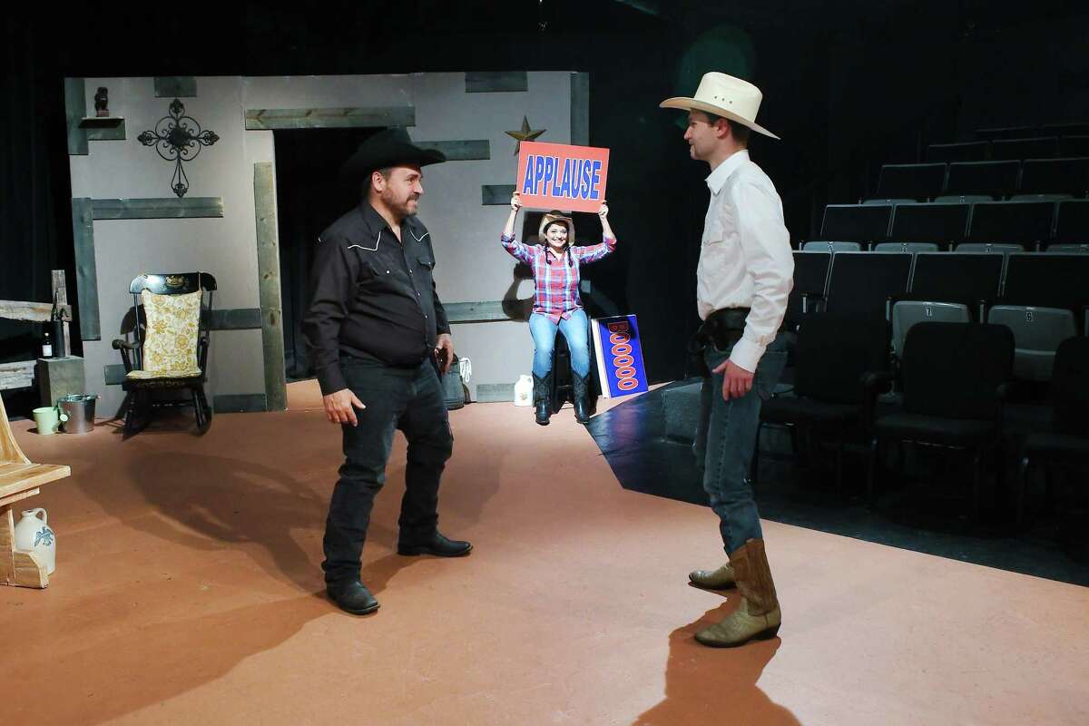 Jeffrey Merriman and Kenton Hammemann square off while Sylvana McIntyre shows one of the signals she will give the audience at intervals during “The Rustlers of Red Rock” at Pasadena Little Theatre.