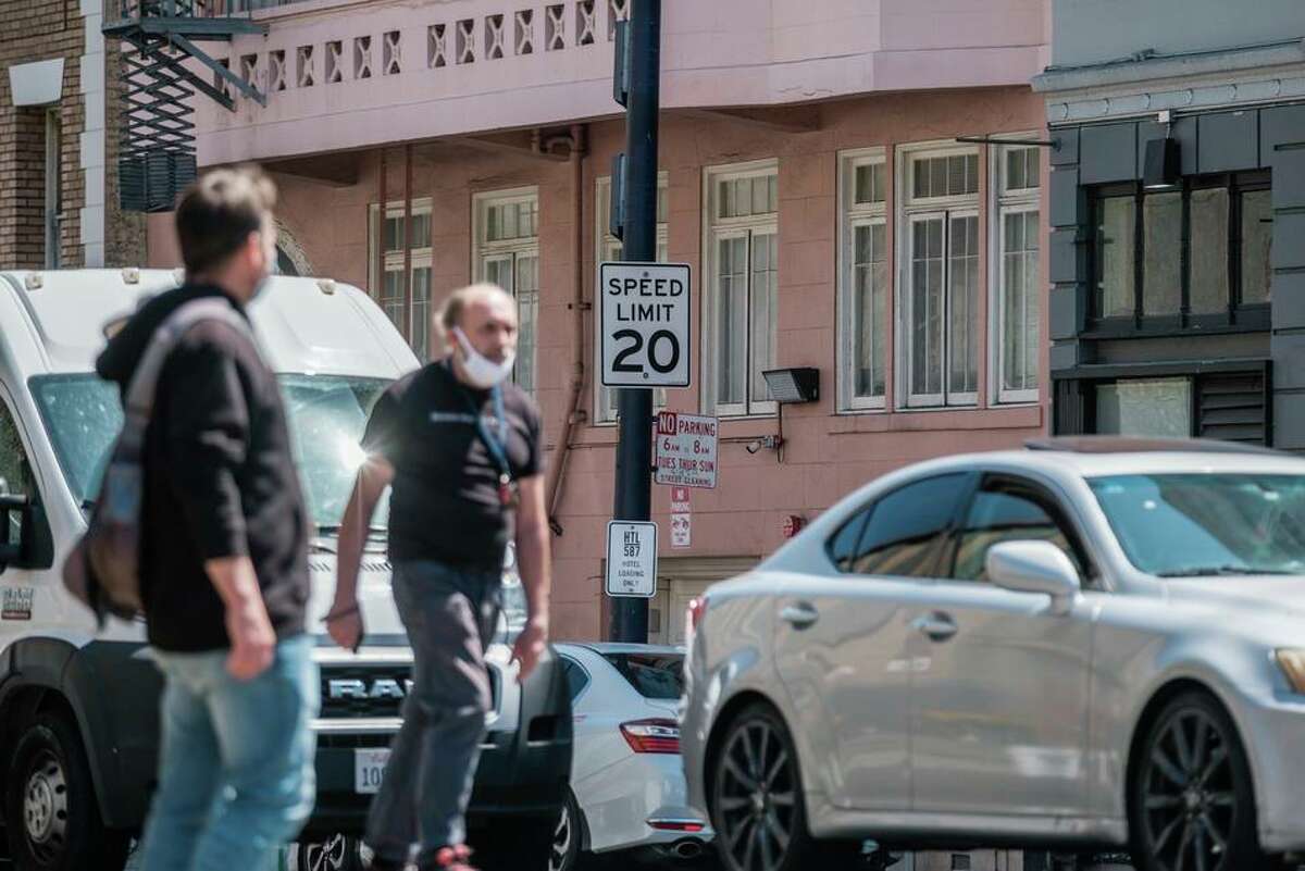 Pedestrians and vehicles in the Tenderloin neighborhood of San Francisco. Lower speed limits have been shown to correlate with decreased traffic fatalities, which is why there is a push to add speed cameras to some corridors in San Francisco.