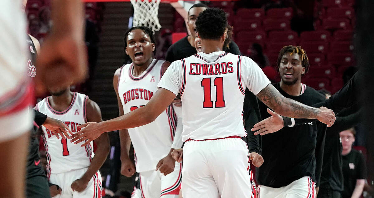 Houston Cougars guard Kyler Edwards (11)celebrates with teammates at a time out during the first half of a men's NCAA basketball game at Fertitta Center on the University of Houston campus on Thursday, March 3, 2022 in Houston.