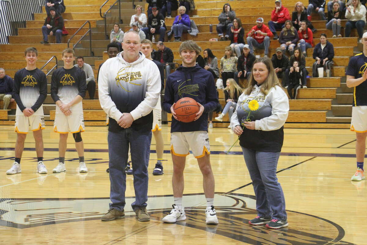 Aaron Sowles with his parents and the game ball.