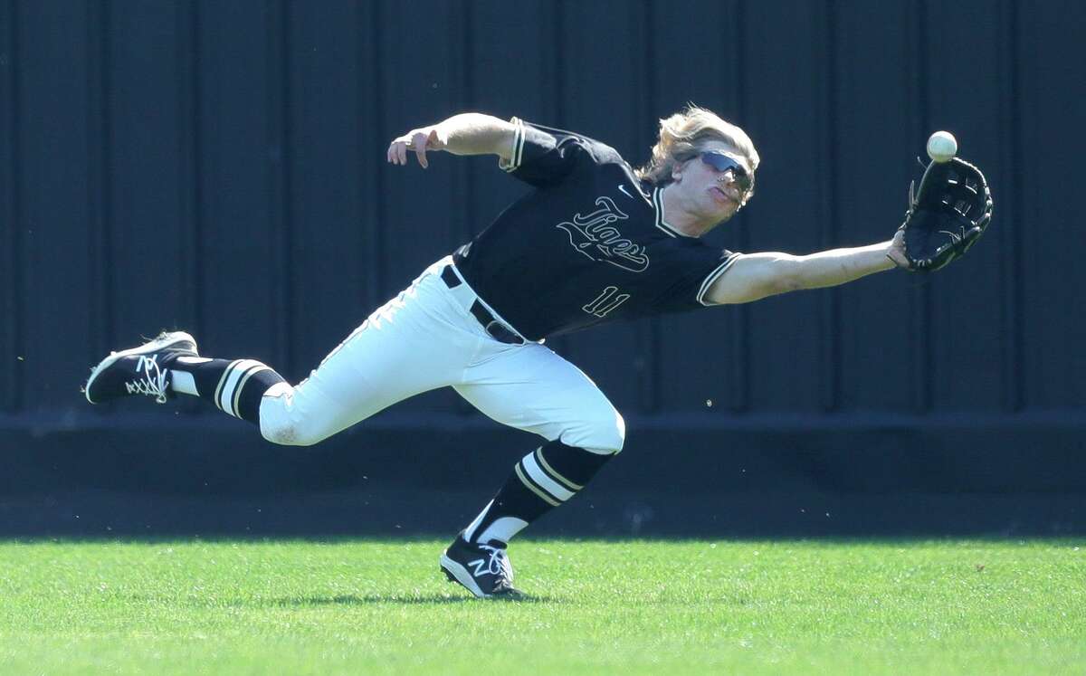 Conroe left fielder Brock Ireland (11) makes a diving catchduring a game against Jersey Village in the Ferrell Classic at Conroe High School, Thursday, March 3, 2022, in Conroe.