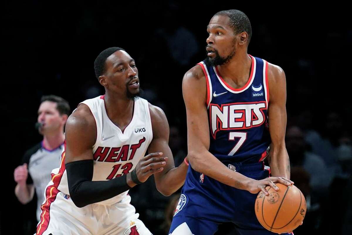 Kevin Durant is guarded by Miami’s Bam Adebayo. Durant scored 31 points in his return from injury, but the Nets lost.
