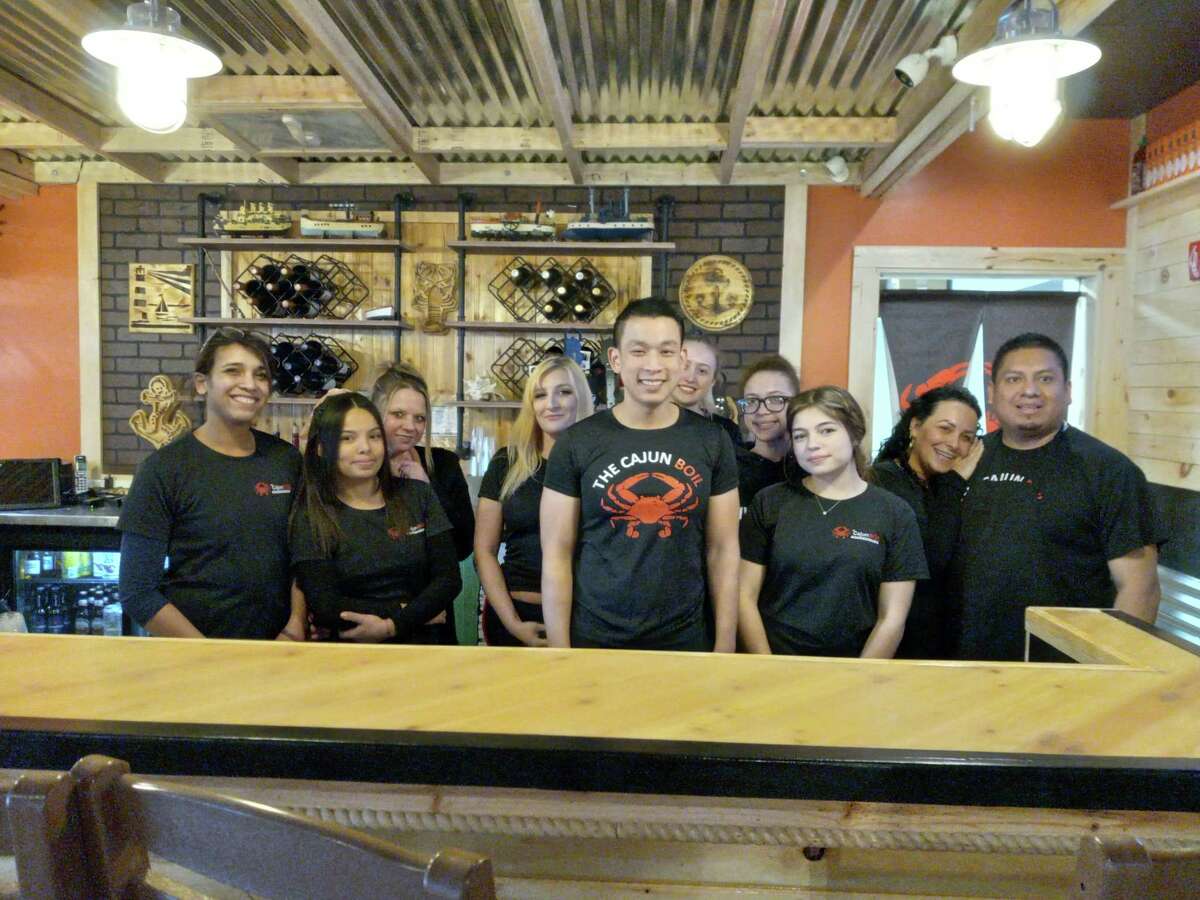 The Cajun Boil seafood restaurant opened Feb. 25 on Winsted Road in Torrington. Owner Linh Duong, center, is joined by his waitresses and kitchen staff behind the bar.
