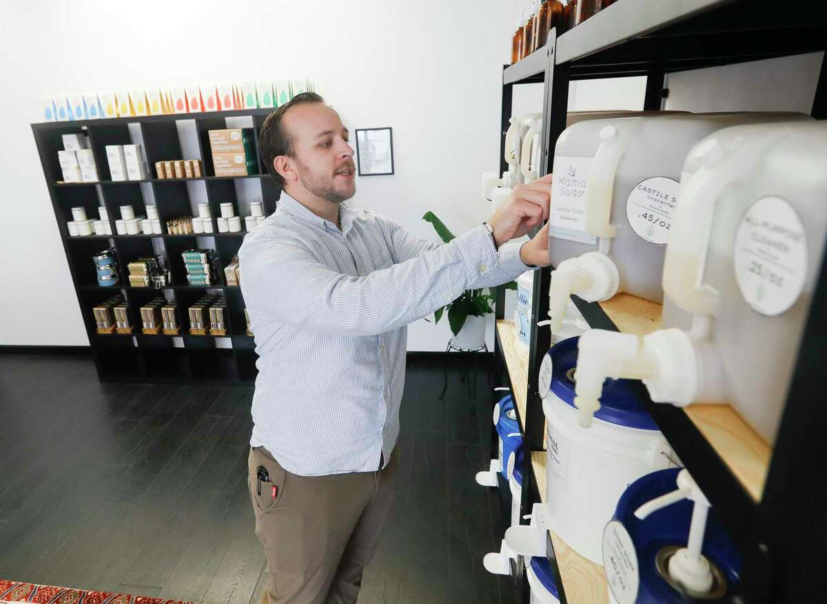 Dylan Harris, owner of Less Refillery, shows some of the products at his newly opened store along FM 1488, Thursday, March 3, 2022, in Magnolia. Harris' goal is to help reduce our reliance on and consumption of single-use plastics by offering household and personal care products in bulk for customers to bring in their own containers to refill. Some things that are for sale are shampoo, laundry detergent, lotion, and hair conditioner, amongst others.