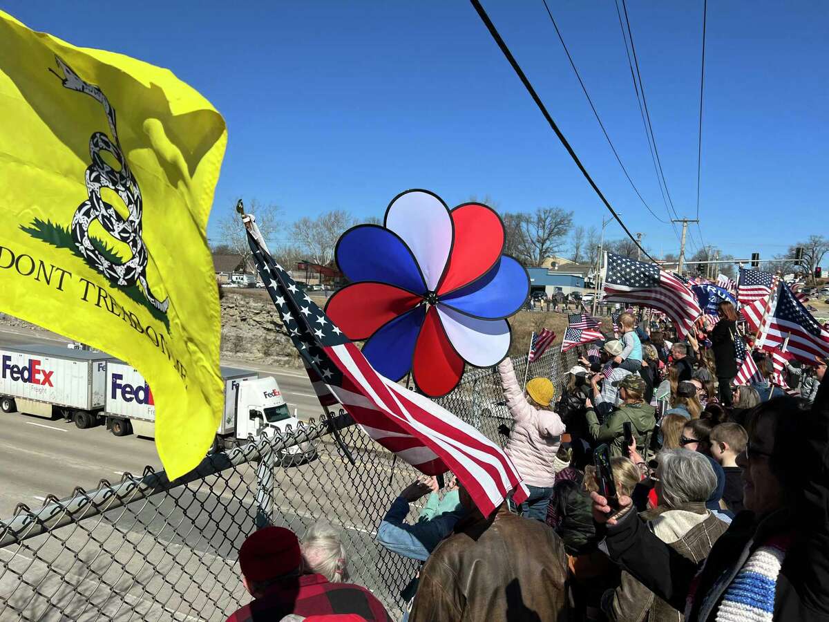 Hundreds of supporters gathered to cheer on the "People's Convoy" from an overpass in Eureka, Mo., on March 1 as the caravan made its way from California to the D.C. area.