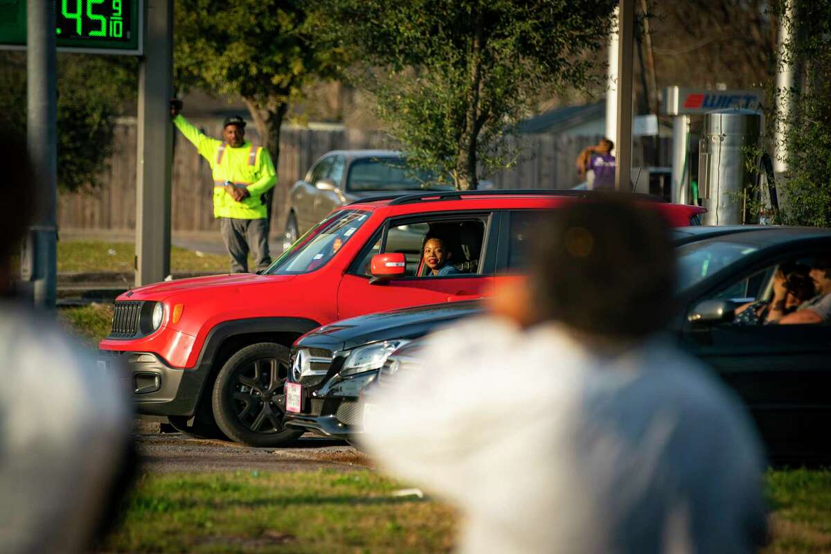 People watch from their cars as Dimitri Reeves performs at the corner of Lockwood Drive and Calvalcade Street, Thursday, March 3, 2022, in Houston. 