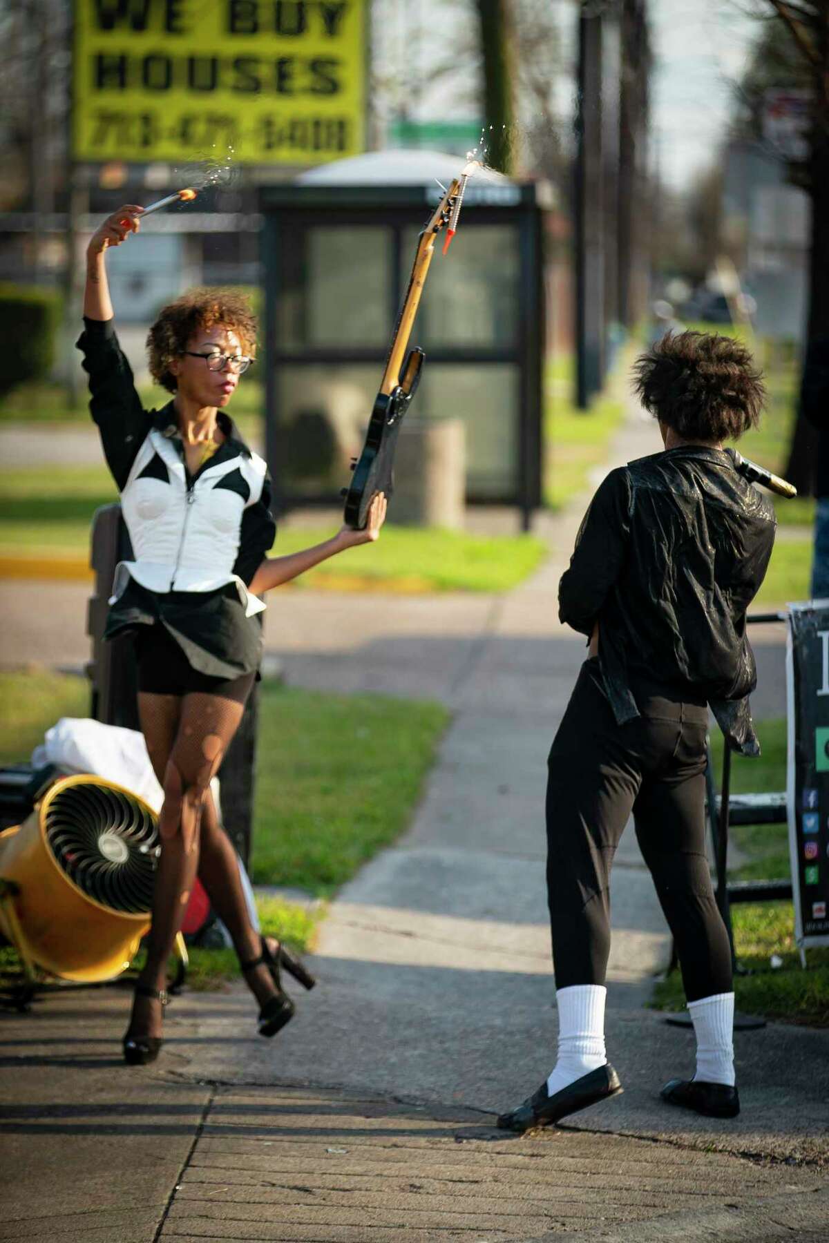 Lee Kimble holds fireworks and a guitar as she performs 