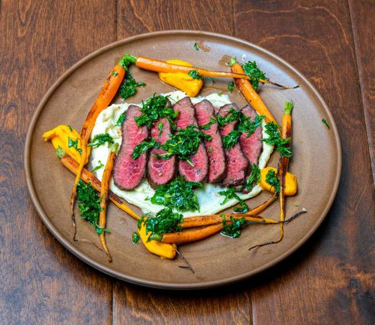 Steak with caramelized onion yogurt, carrots and carrot top chimichurri at Ceron Kitchen in Alameda.