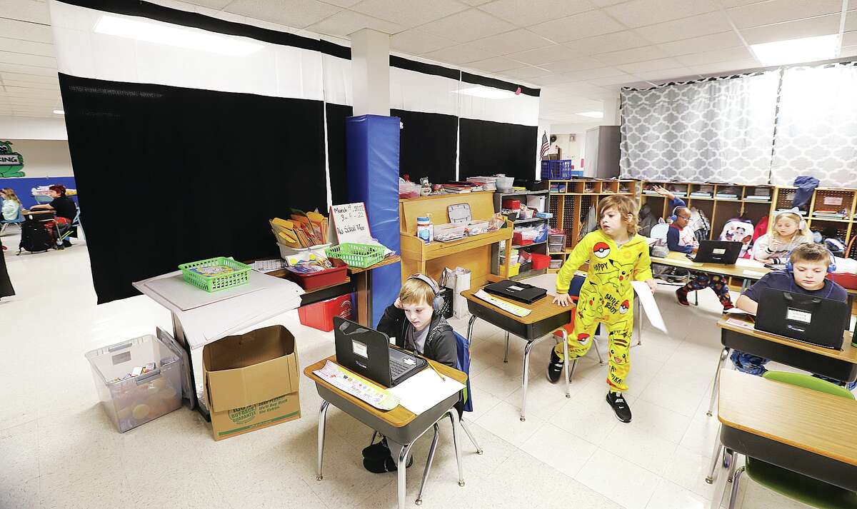 John Badman|The Telegraph Several displaced Lewis and Clark Elementary School students are using makeshift classrooms set up in the basement of Hartford Elementary School. Dividers, some of them shower curtains, separate the basement classrooms.