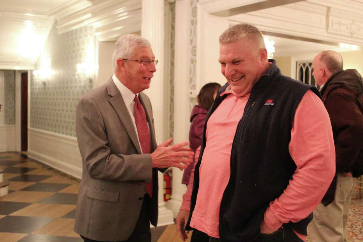 Ridgefield Selectman Bob Hebert, left, mingles with Republican registrar of voters Wayne Floegel, before announcing his campaign to represent the town in Hartford in the 111th House district. Thursday, March 3, 2022, in Ridgefield, Conn.