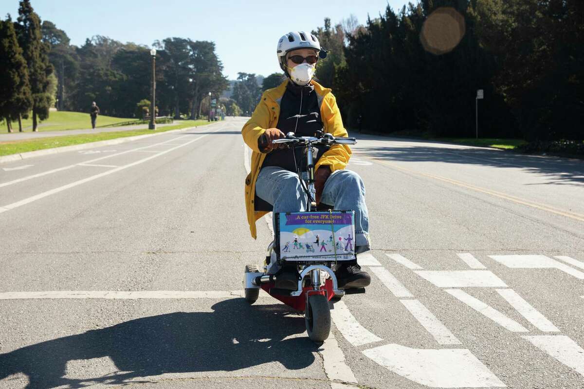 Carol Brownson, 80, rides her mobility scooter along JFK Drive in San Francisco. Opponents of car-free JFK Drive in Golden Gate Park say people who are disabled or elderly are unable to use it.