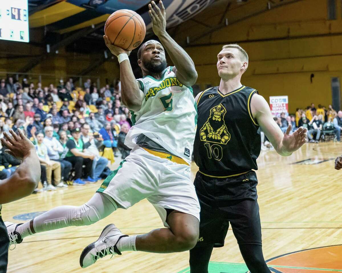 Albany Patroons guard Mike Williams drives to the basket in front of Massachusetts Monarchs forward Zach Turcotte during The Basketball League season opener at the Washington Avenue Armory in Albany, NY, on Friday, March 4, 2022. (Jim Franco/Special to the Times Union)