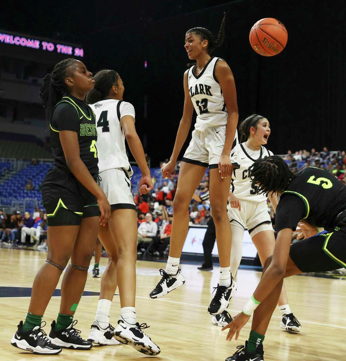 Clark's Arianna Roberson (12) leaps into the air after scoring a shot at the buzzer against DeSoto in the UIL Class 6A girls basketball semifinal game at the Alamodome on Friday, Mar. 4, 2022.