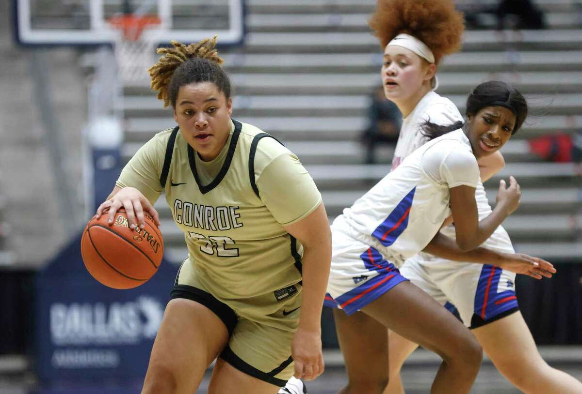 Conroe’s Isabella Stafford (32) handles the ball as Duncanville’s Kaylinn Kemp (12) looks on during the semifinals of the Regional II-6A girls basketball tournament at Davis Fieldhouse Friday, Feb. 25, 2022, in Dallas, Texas. (AP Photo/Ron Jenkins)