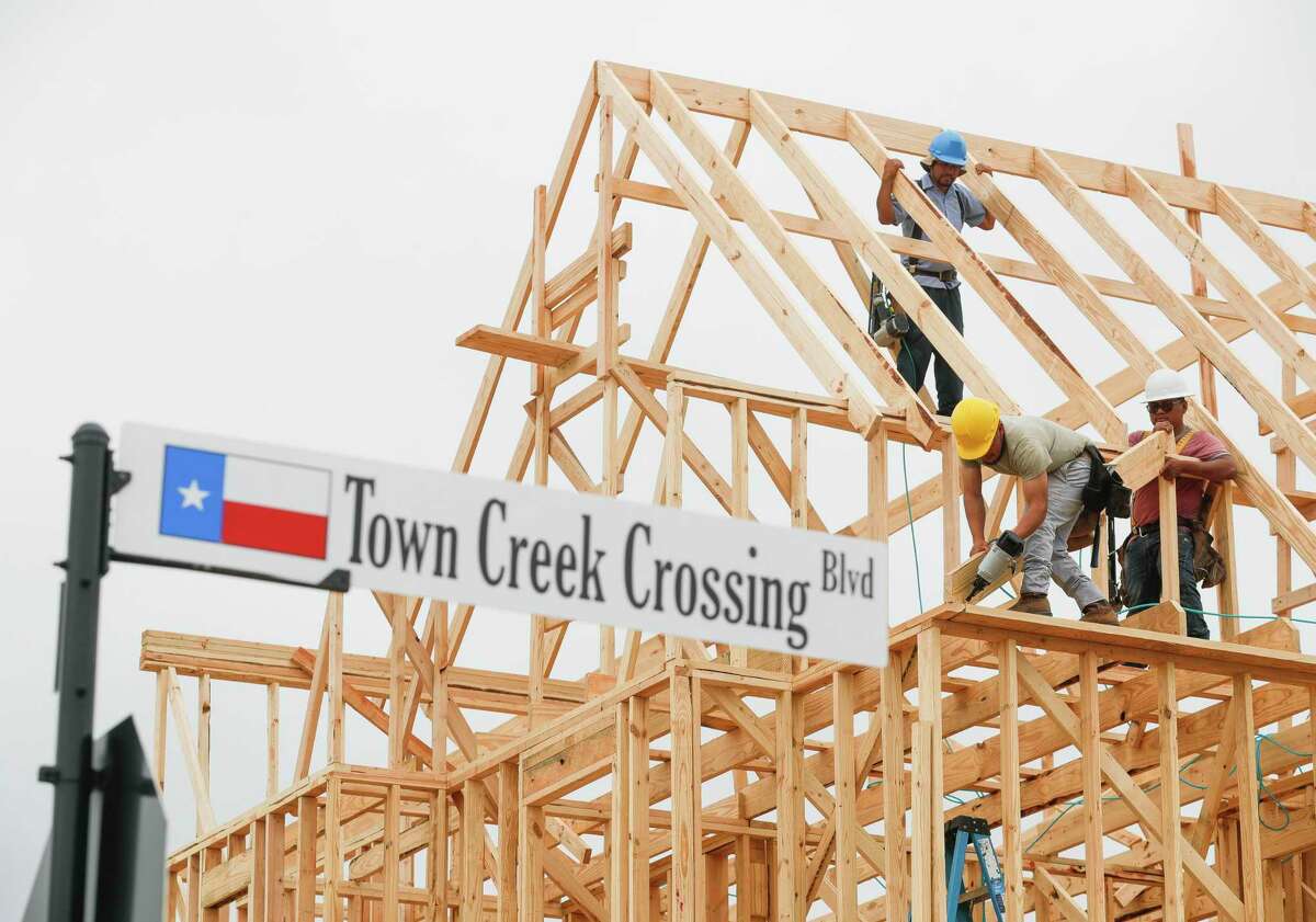 Workers put up framing for a home under construction in the Town Creek Crossing subdivision, Friday, March 4, 2022, in Montgomery.