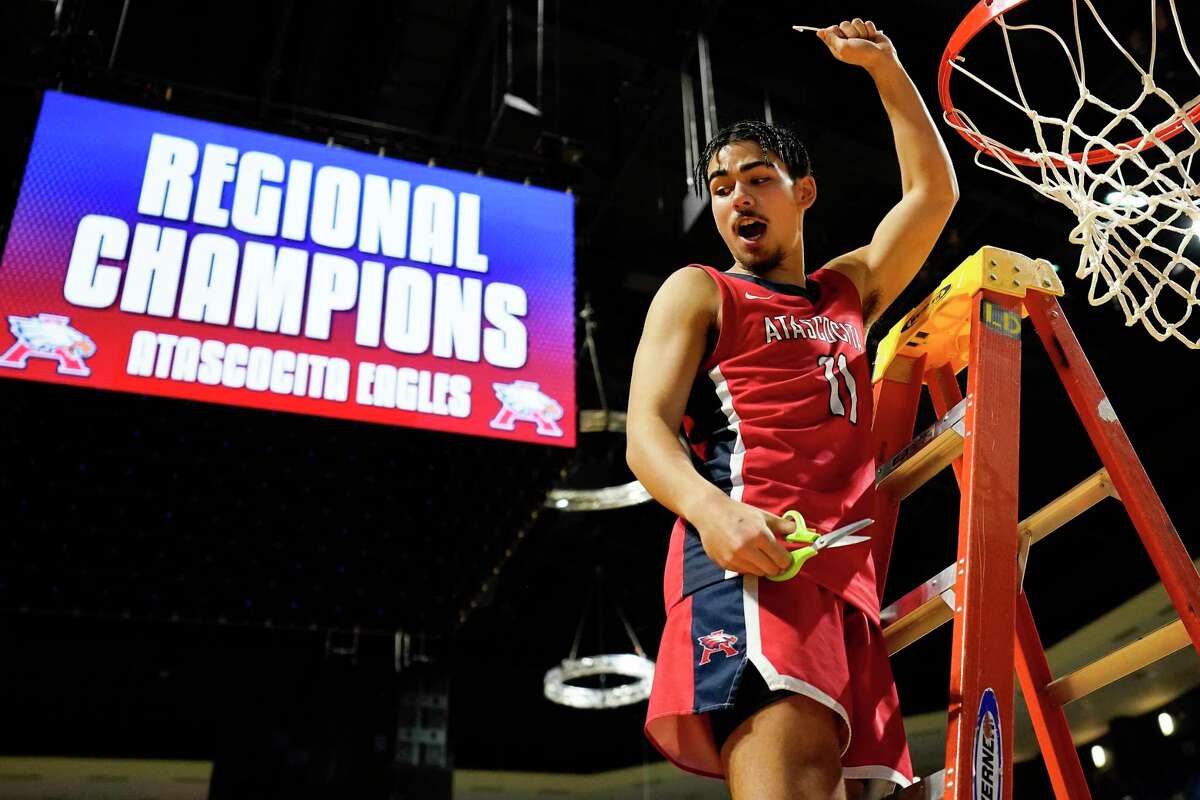 Atascocita’s Gabe Acay celebrates after cutting down the net following the team’s victory over Shadow Creek in the Region III-6A final high school basketball playoff game, Saturday, March 5, 2022, in Cypress, TX.