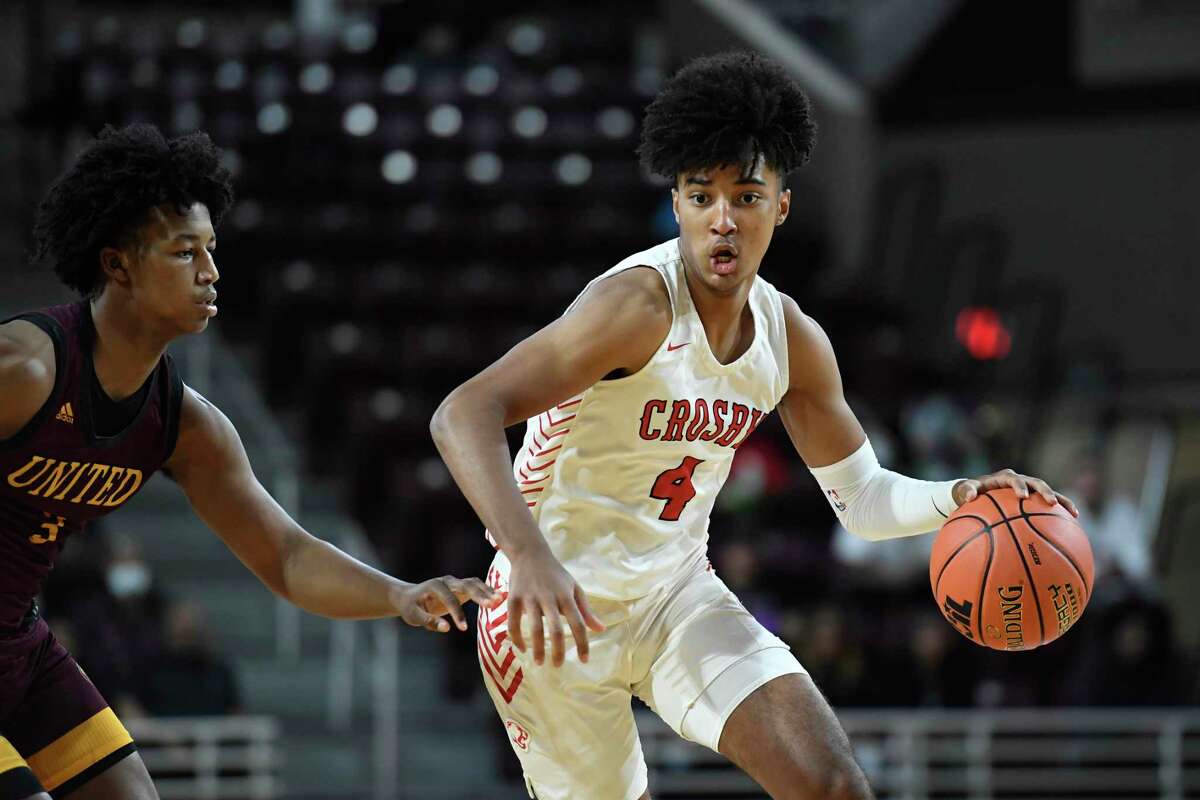 Crosby’s PJ Haggerty (4) brings the ball up court against Beaumont United’s Wesley Yates (3) during the first half of the Region III-5A championship in the M.O. Campbell Education Center Saturday, March 5, 2022, in Houston, Texas.