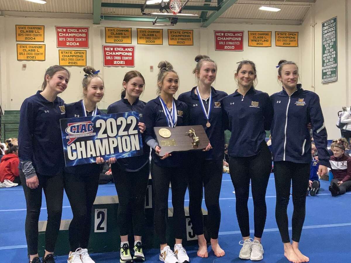 Woodstock Academy celebrates after winning the State Open gymnastics title on Saturday.