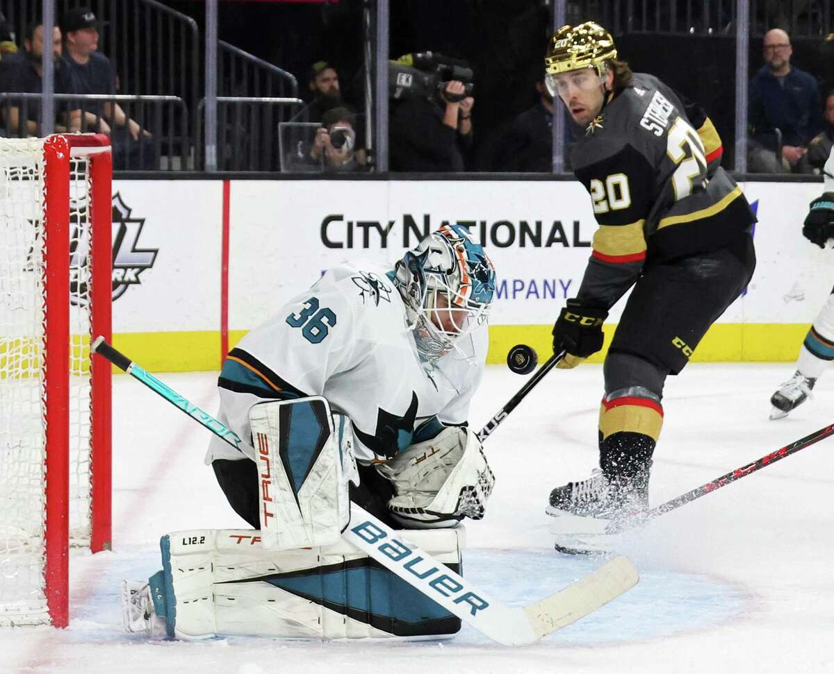 Zach Sawchenko #36 of the San Jose Sharks makes a save as Chandler Stephenson #20 of the Vegas Golden Knights looks for a rebound in the second period of their game at T-Mobile Arena on March 01, 2022 in Las Vegas, Nevada. The Golden Knights defeated the Sharks 3-1.
