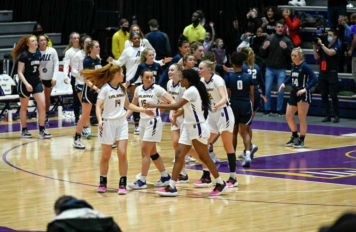 Albany players celebrate a 49-44 win against New Hampshire during an NCAA America East basketball quarterfinal game Saturday, March 5, 2022, in Albany, N.Y.