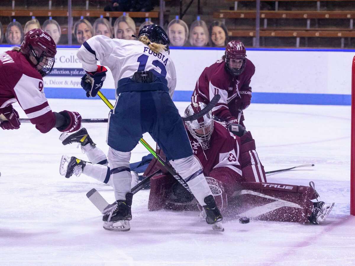 Colgate goaltender Hannah Murphy makes a pad save in front of Yale’s Rebecca Foggia on Saturday.