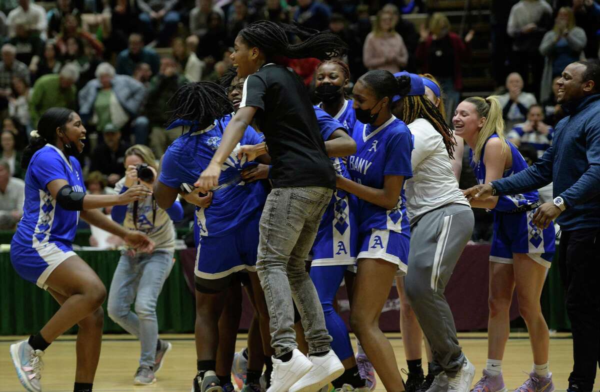 Albany basketball players flood onto the court following their victory over Shenendehowa in the Class AA Championship on Saturday, Mar. 5, 2022 at Hudson Valley Community College in Troy, N.Y. (Jenn March, Special to the Times Union)