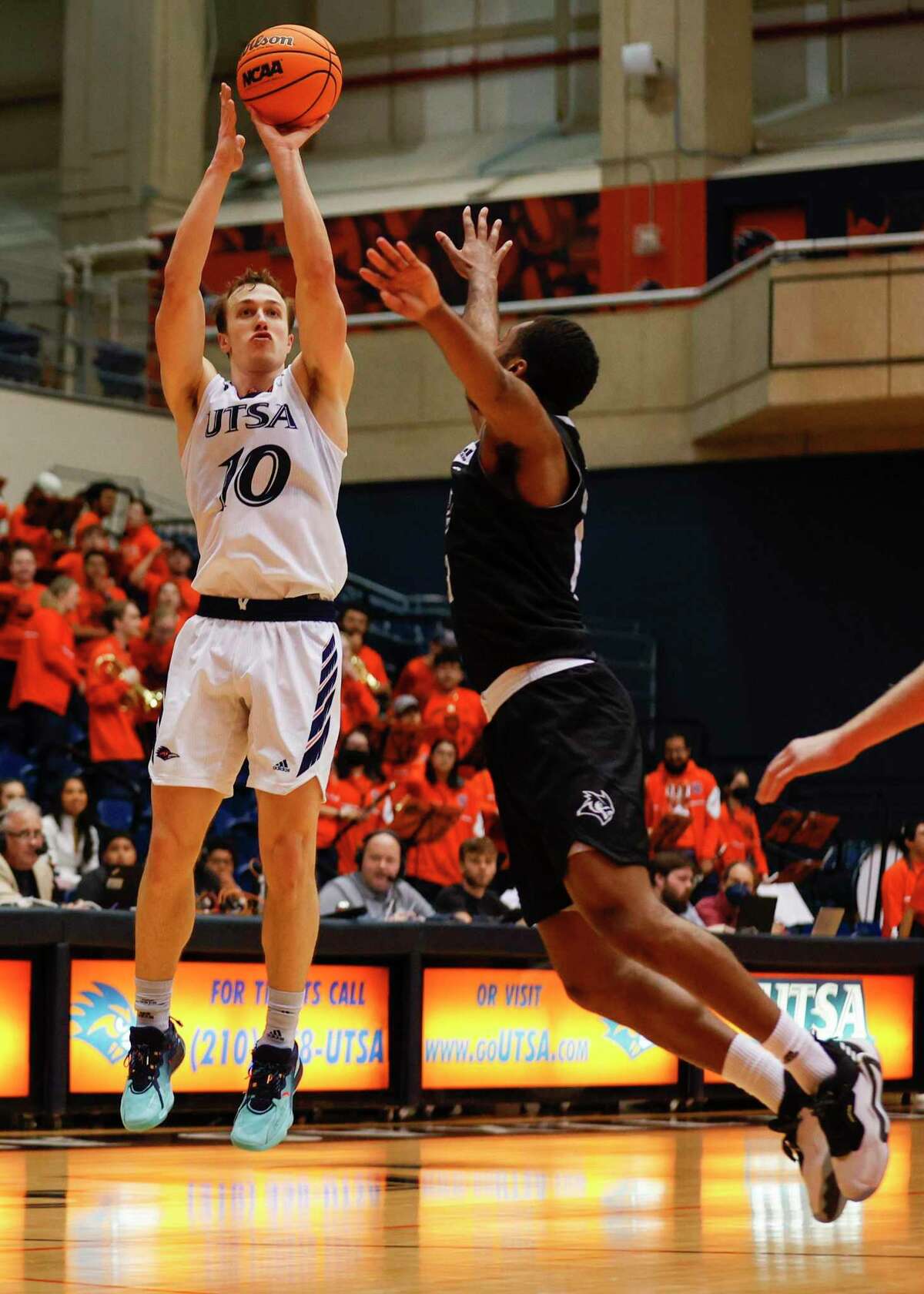 UTSA guard Erik Czumbel (10) shoots a three-pointer over Rice guard Terrance McBride (13) during the second half at the Convocation Center, Saturday, March 5, 2022 in San Antonio, Texas. The Roadrunners defeated the Owls 82-71.