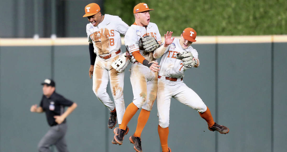 Texas players Dylan Campbell (8) (from left), Eric Kennedy (30) and Douglas Hodo (7) celebrate what they thought was the last out against LSU during the Shriners Children's College Classic at Minute Maid Park on Saturday, March 5, 2022 in Houston.