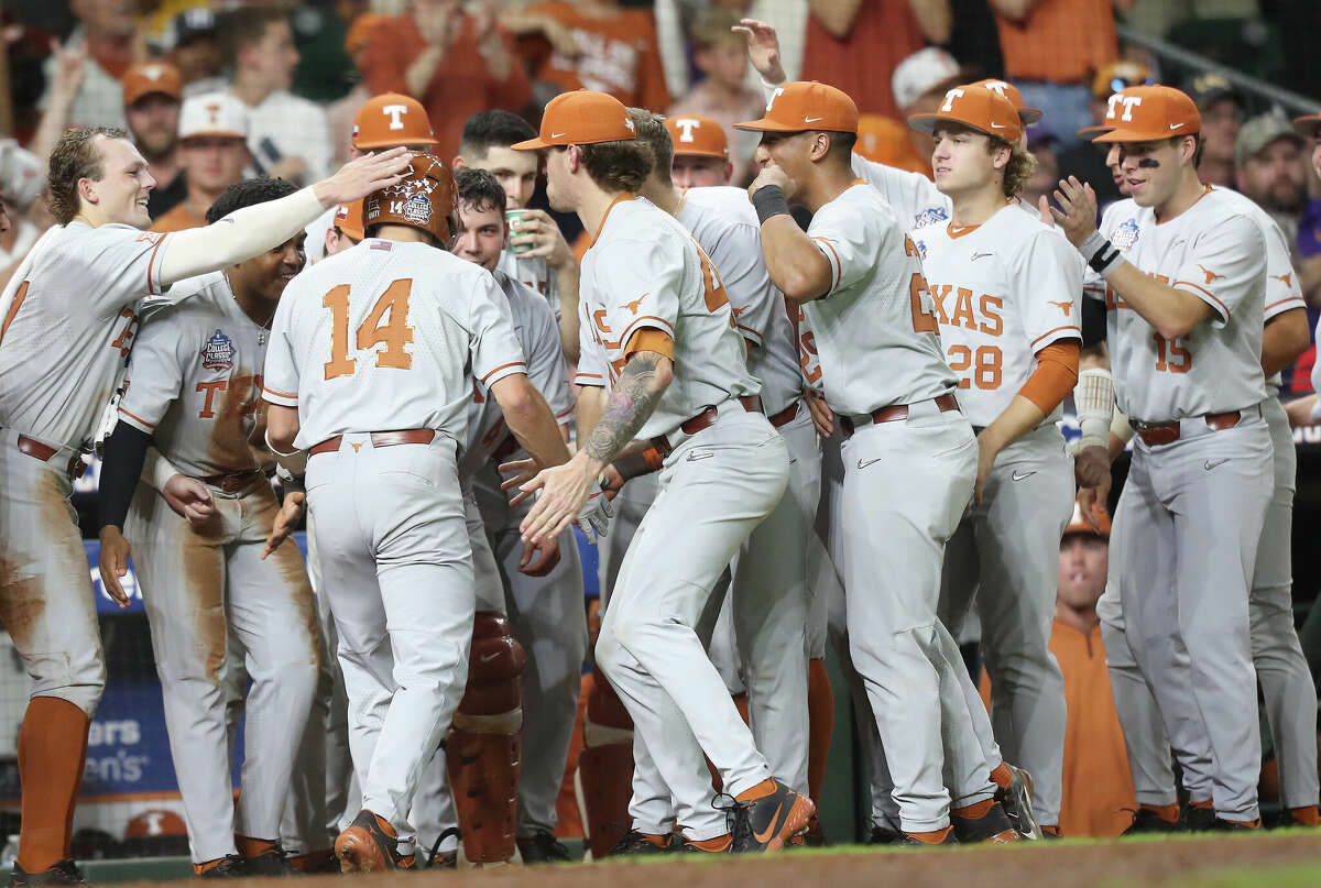 Texas infielder Murphy Stehly (14) is congratulated by the dugout after hitting a solo home run in the eighth inning against LSU during the Shriners Children's College Classic at Minute Maid Park on Saturday, March 5, 2022 in Houston.