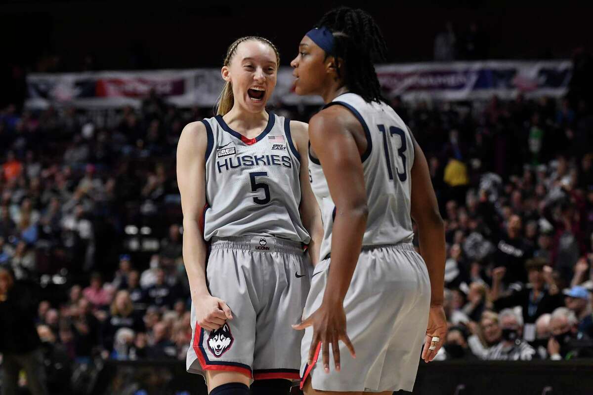UConn’s Paige Bueckers (5) reacts toward teammate Christyn Williams during a Big East Tournament semifinal game against Marquette on March 6.