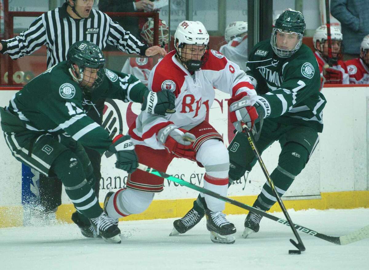 Jack Agnew of RPI, center, gets through two Dartmouth players as he brings the puck up the ice during their game on Sunday, March 6, 2022, in Troy, N.Y.
