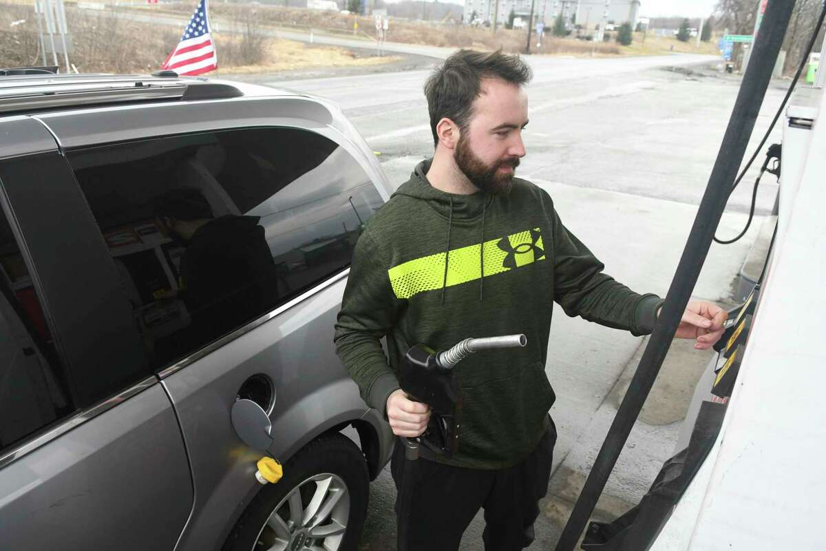 Kyle Kierce, of Southington, Connecticut, gets gas at the Conoco gas station off I-81 near Mahanoy City, Pa., on Sunday morning, March 6, 2022. He was traveling with a group from Connecticut to Nashville and stopped for gas. The price of regular gas on Sunday morning at the station was $4.09. The price of regular gasoline broke $4 per gallon on average across the U.S. on Sunday for the first time since 2008. (Jacqueline Dormer/Republican-Herald via AP)