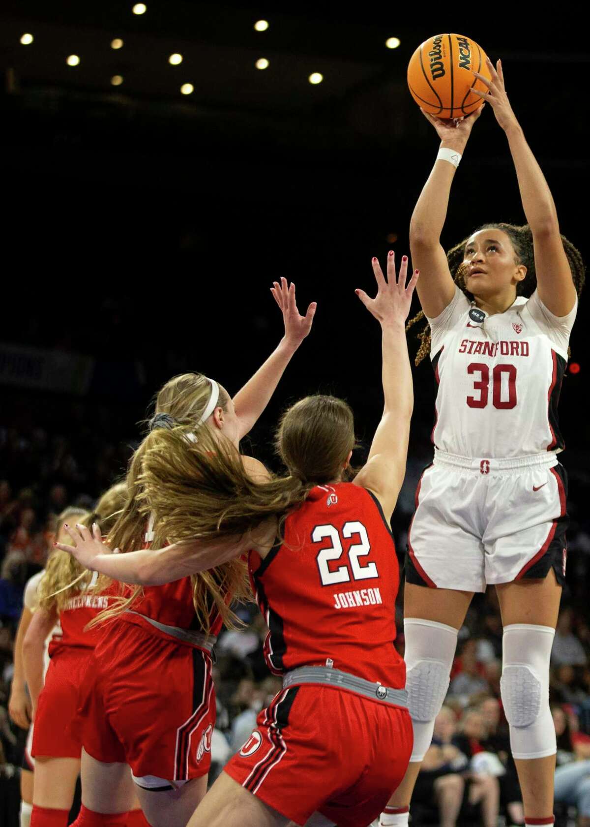 Stanford guard Haley Jones (30) shoots against Utah guard Dru Gylten, left, and forward Jenna Johnson (22) during the second half of an NCAA college basketball game for the Pac-12 tournament championship Sunday, March 6, 2022, in Las Vegas. (AP Photo/Ellen Schmidt)