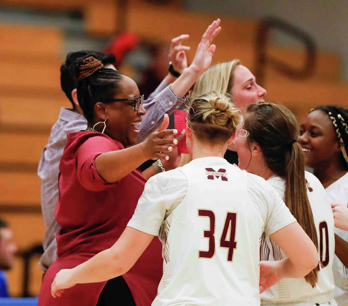 Magnolia West coach Darcie Moore celebrates after rallying for a 44-41 win over Lake Creek during a Region III-5A