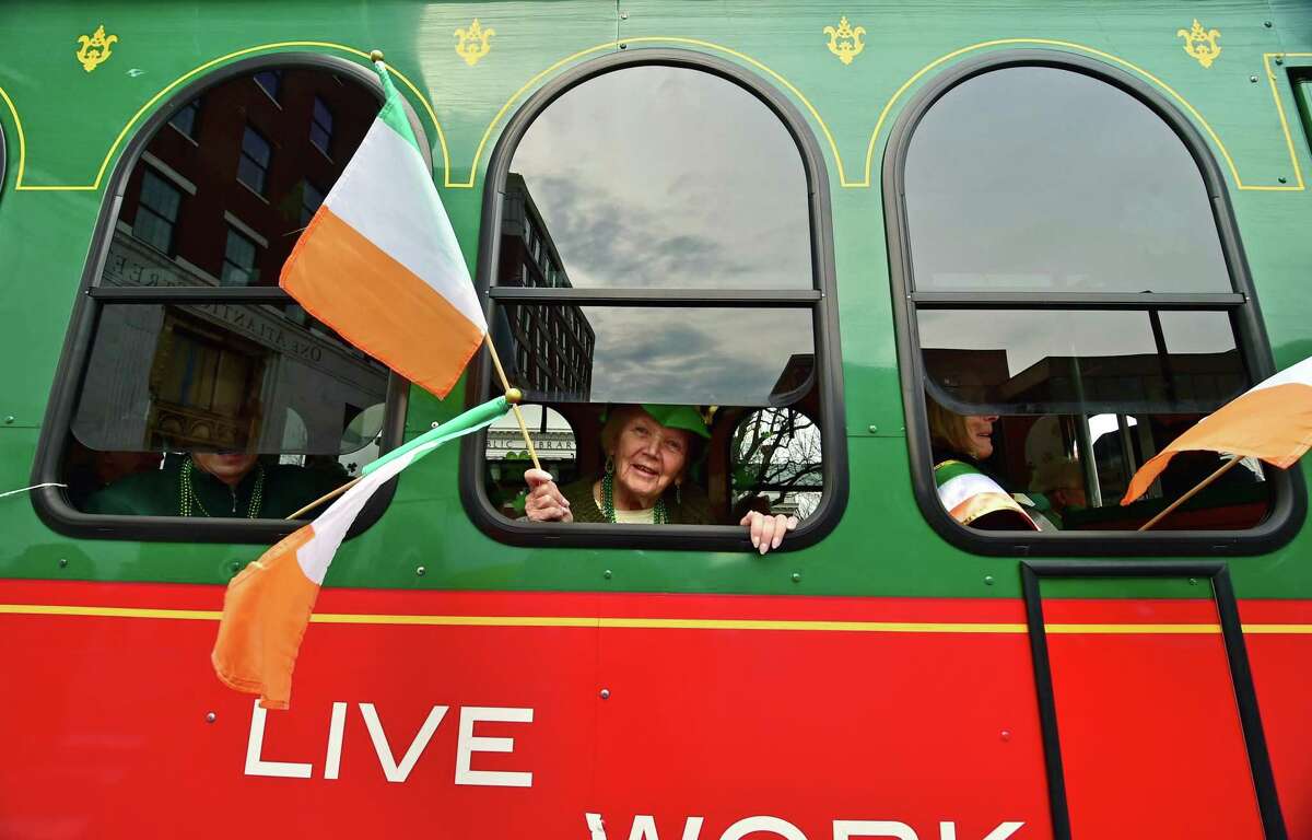 Bridget Ormond waves an Irish flag during the 27th annual St. Patrick's Day Parade in downtown Stamford, Conn., on Saturday, March 5, 2022.